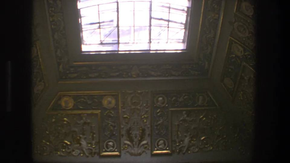 1975 Denmark 8mm frame of the cathedral interior ceiling, showing blue-and-gold ornament and a bright overhead skylight.