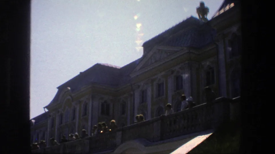 1975 Denmark 8mm frame of a palace terrace and steps, with visitors silhouetted along the balustrade.