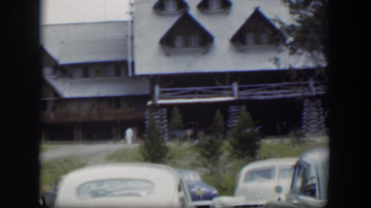 Parked cars in front of a rustic lodge, with the contact-sheet border visible.