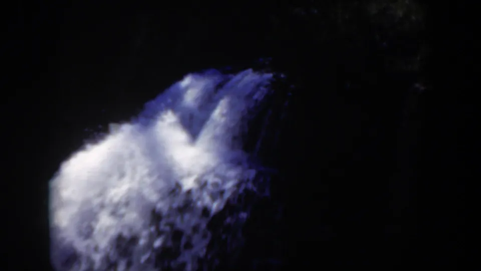 1951 Wyoming 8mm frame showing a bright blue-white waterfall against a nearly black forest background.
