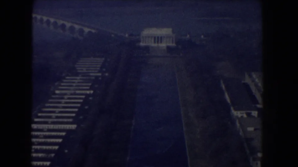 1960 aerial view of the Lincoln Memorial and Reflecting Pool, with bridge arches and surrounding parkland visible through dark 8mm exposure.