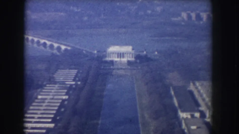 1960 aerial 8mm view over Washington, DC, showing the Lincoln Memorial, Reflecting Pool, and Arlington Memorial Bridge.