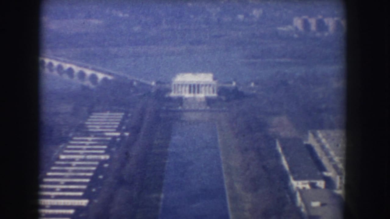 1960 Washington, DC aerial frame with the Lincoln Memorial above the Reflecting Pool and bridge visible in the distance.