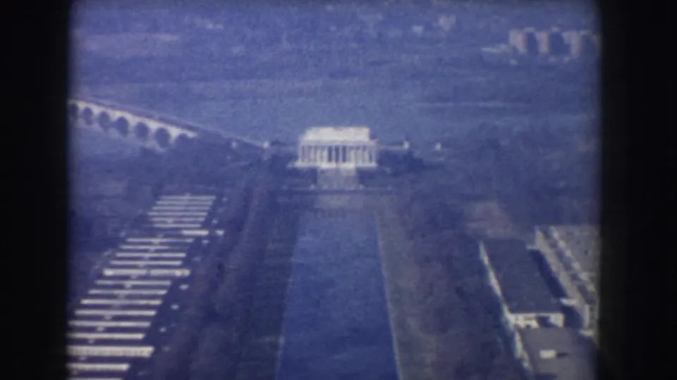 1960 Washington, DC aerial frame with the Lincoln Memorial above the Reflecting Pool and bridge visible in the distance.