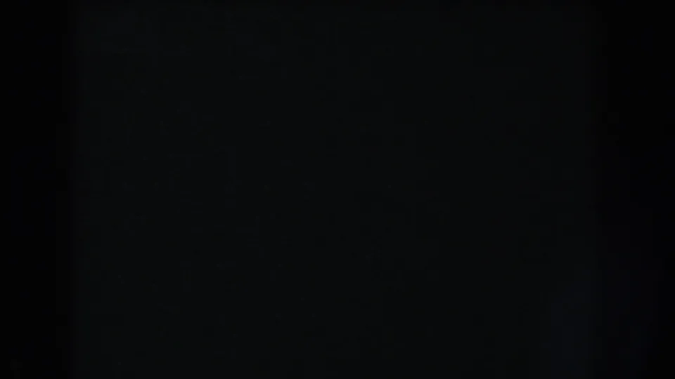 Nearly black 8mm frame from a Washington, DC home-movie reel, with no identifiable subjects or setting visible.