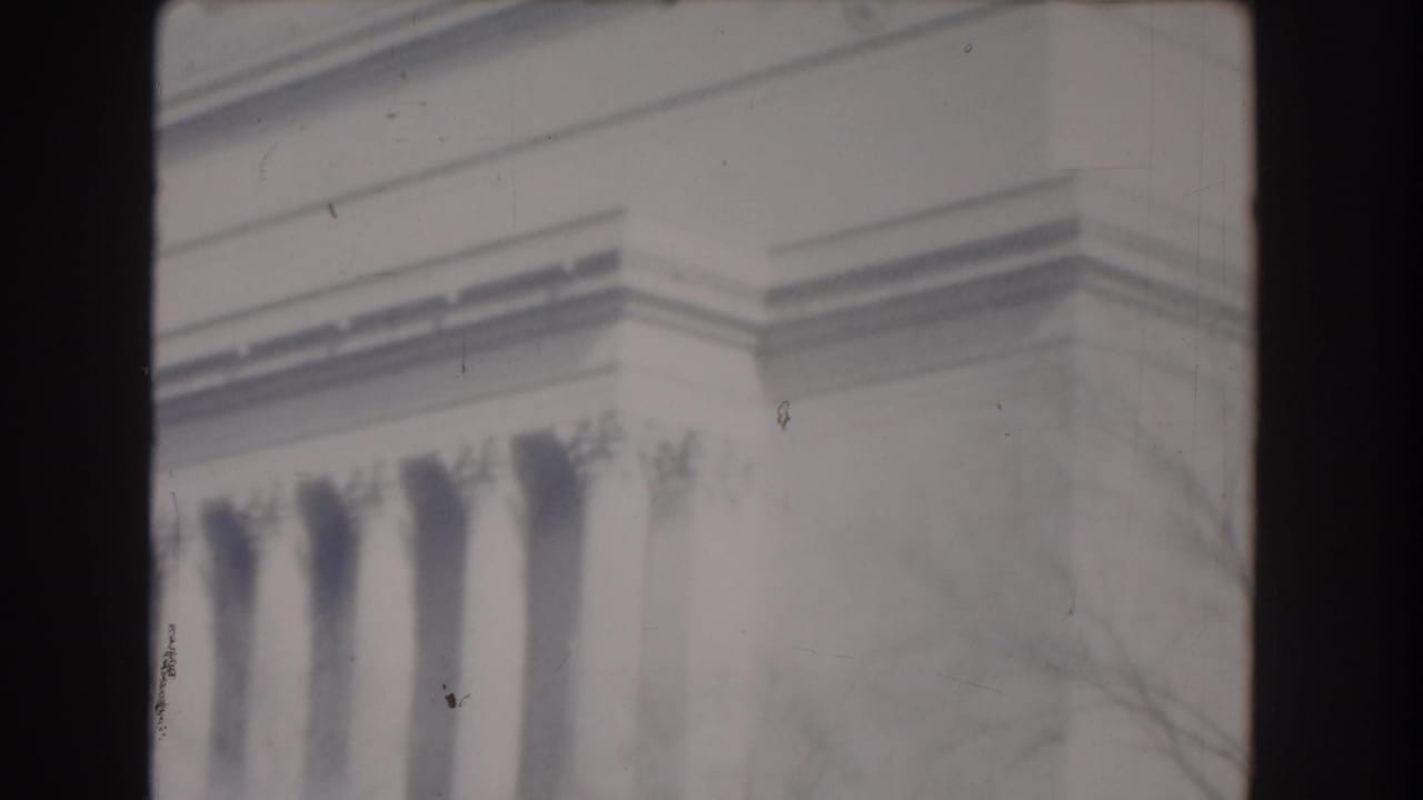 Partial view of Jefferson Memorial columns and upper stone facade.