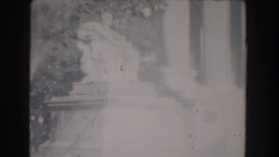 1960 Washington, DC frame showing a pale Jefferson Memorial base or steps, nearby columns, shrubs, and trees.