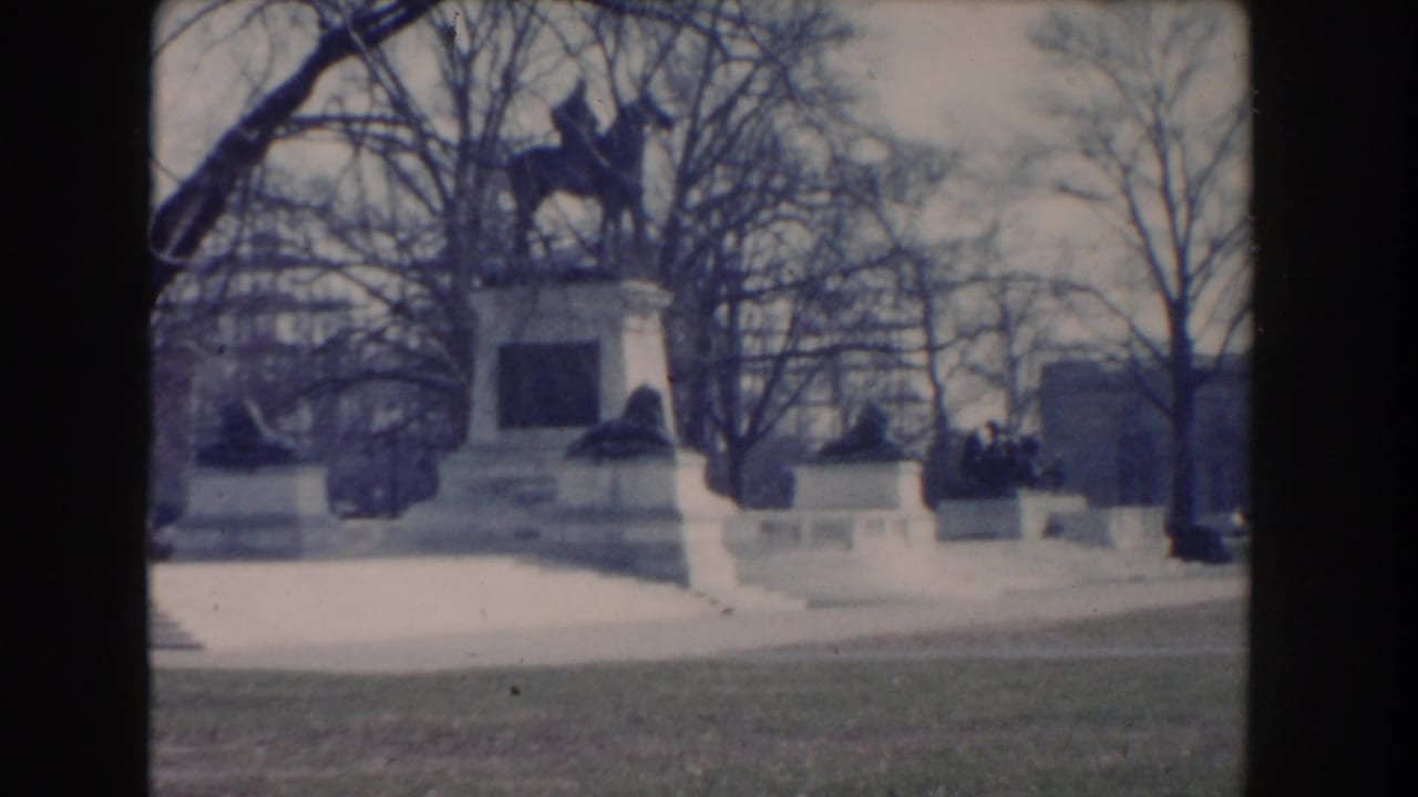 Equestrian monument and surrounding trees viewed from a similar angle.