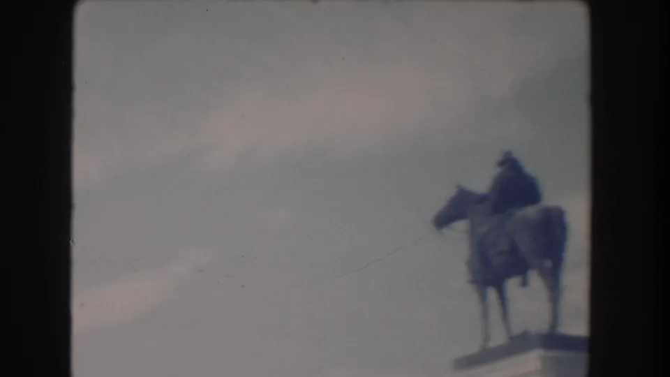 Soft 8mm Washington DC view of an equestrian statue on a pedestal, with the horse and rider partly silhouetted.