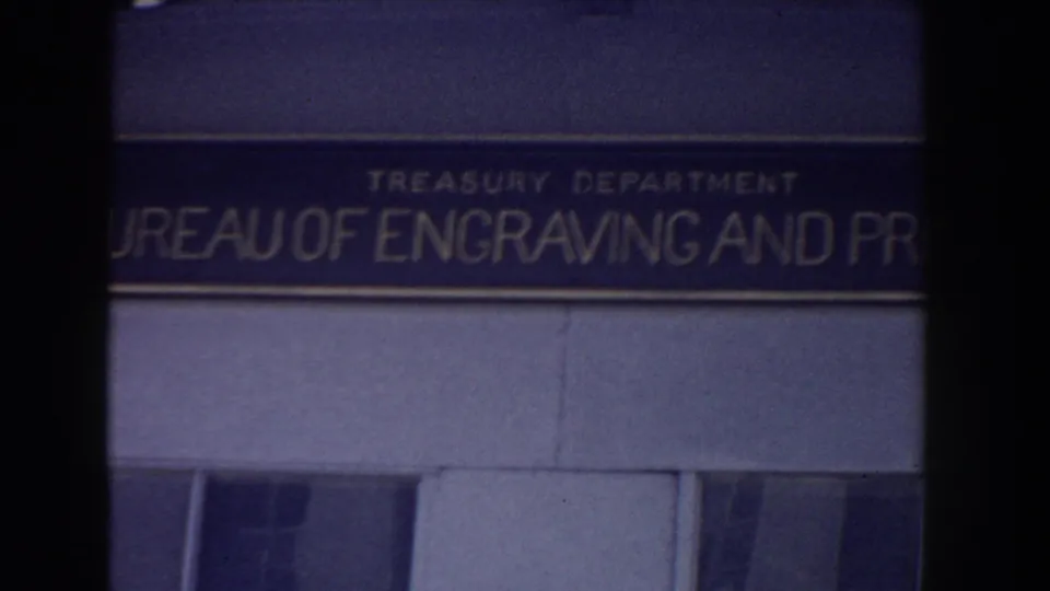 Close 1960 Washington DC frame of the Treasury Department Bureau of Engraving and Printing sign on an official building facade.