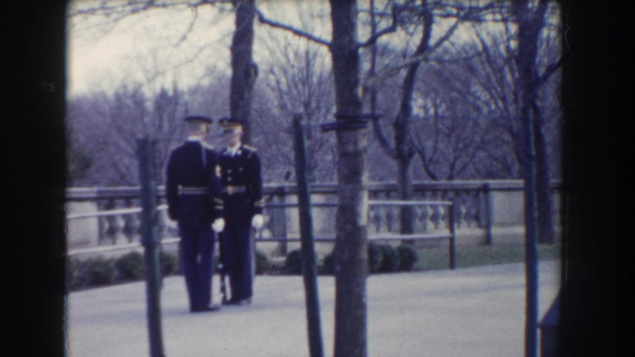 Two dress-uniformed military figures appear to confer or stand at attention on Washington, DC grounds in 1960-era footage.