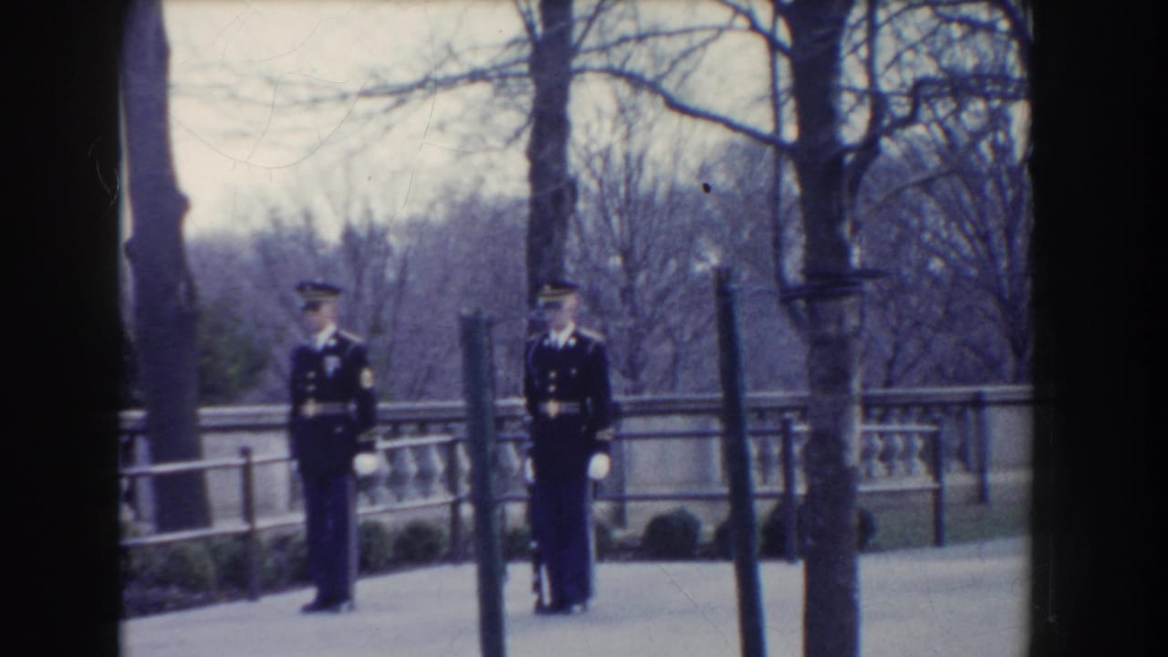 Two military guards in formal uniforms stand near a stone balustrade in Washington, DC, filmed on 8mm in 1960.