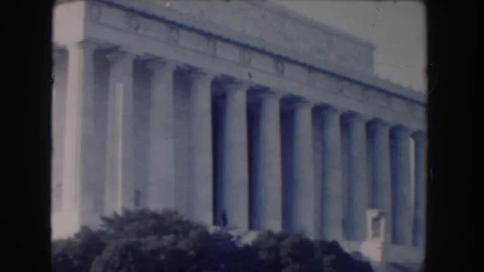 1960 8mm view of the Lincoln Memorial columns in Washington, DC, seen from nearby grounds.