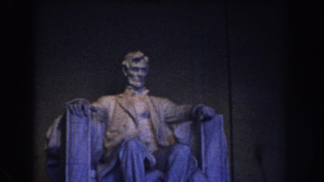 The Lincoln Memorial statue is framed more clearly, with the seated figure lit against a dark interior wall in Washington DC.