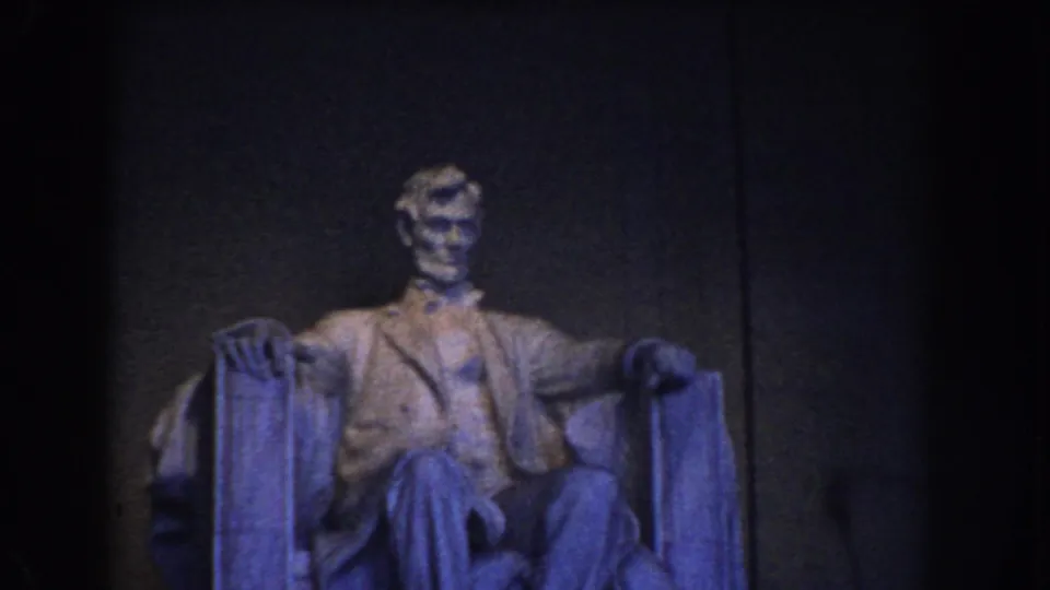 The Lincoln Memorial statue is framed more clearly, with the seated figure lit against a dark interior wall in Washington DC.