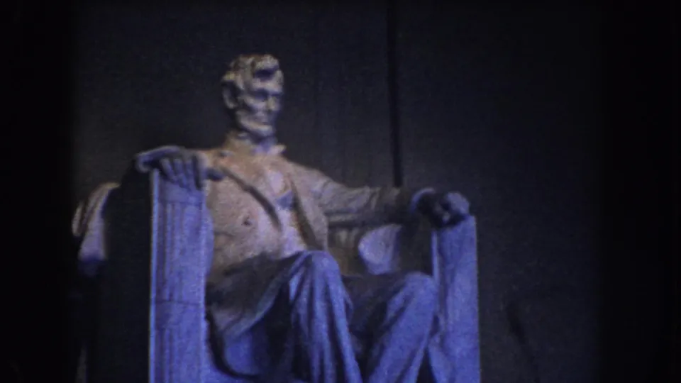 A closer angled 8mm frame shows the Lincoln Memorial statue with blue-tinted illumination and a dark stone backdrop.