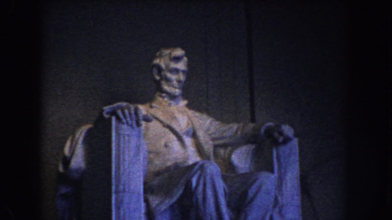 1960 Washington DC frame showing the Lincoln Memorial statue from a visitor viewpoint in dim blue-toned light.