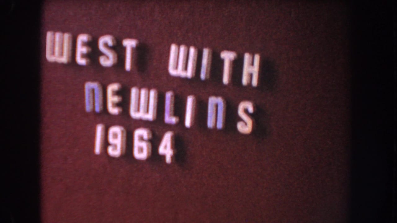 Raised letters spell “WEST WITH NEWLINS 1964” on a burgundy background.