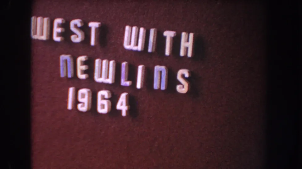 Washington, DC metadata-supported 8mm frame showing a static burgundy title card with raised letters reading “WEST WITH NEWLINS 1964.”
