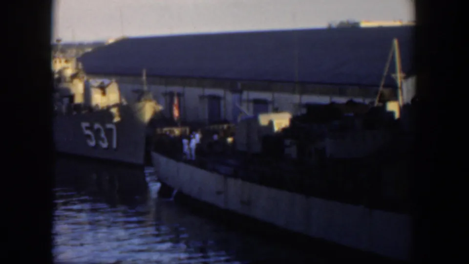 1951 Cuba waterfront view with a docked vessel marked 537, nearby boats, water, and a large building in the background.