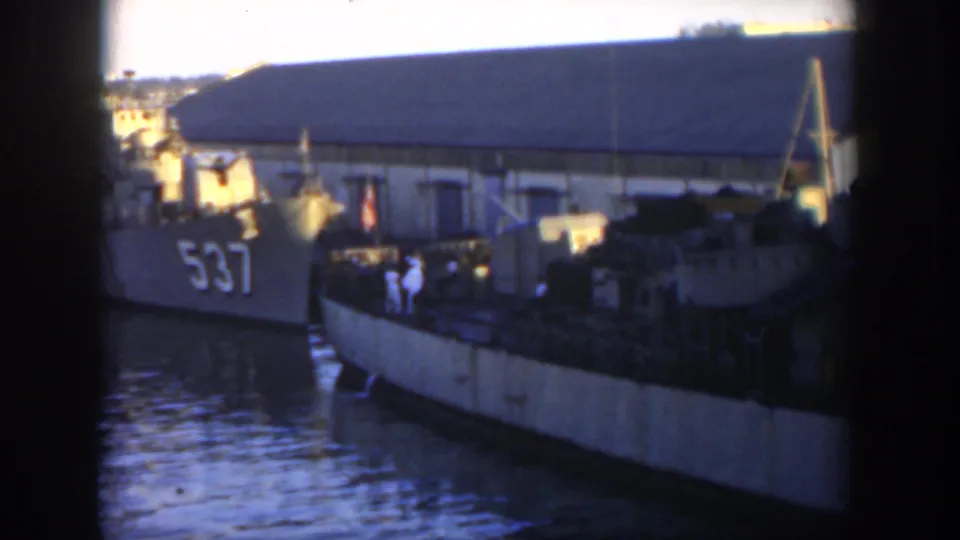 1951 Cuba harbor frame showing the vessel marked 537 at a pier with water, another boat, and a large waterfront building.