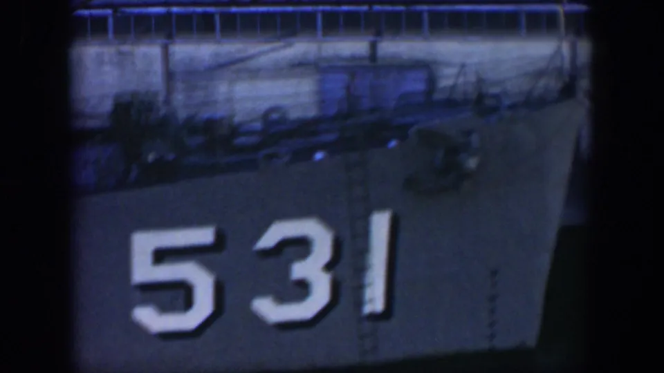 1951 Cuba home-movie frame showing a docked gray vessel with hull number 531 and deck fittings above the side.