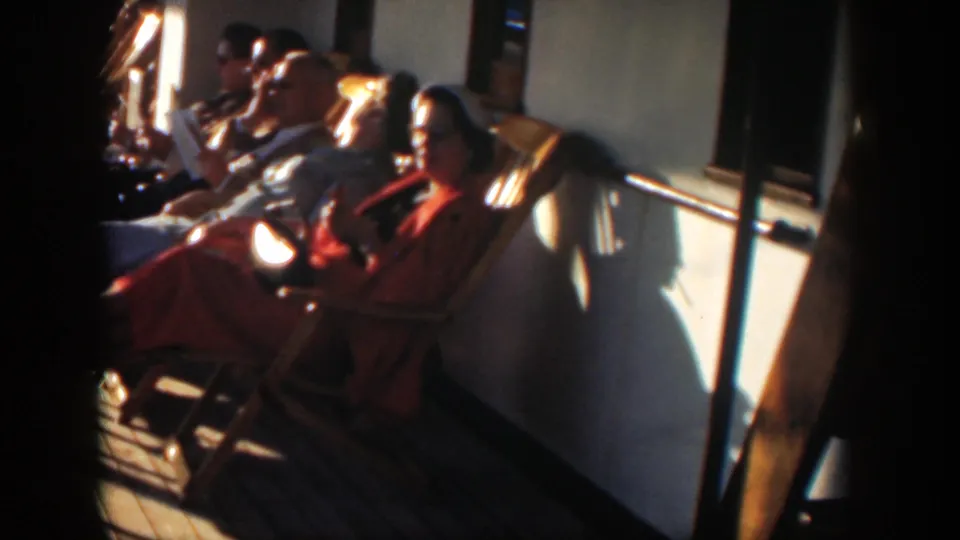 Cuba 1951 home-movie frame showing seated passengers along a boat rail in bright sunlight.