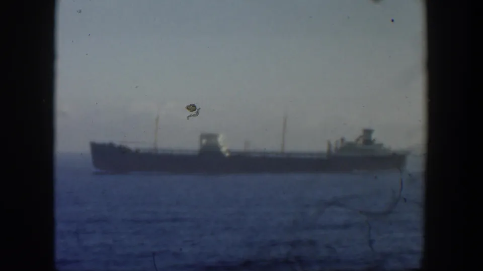A distant vessel remains centered on the horizon in 1951 Cuba-area home-movie footage with visible film wear.
