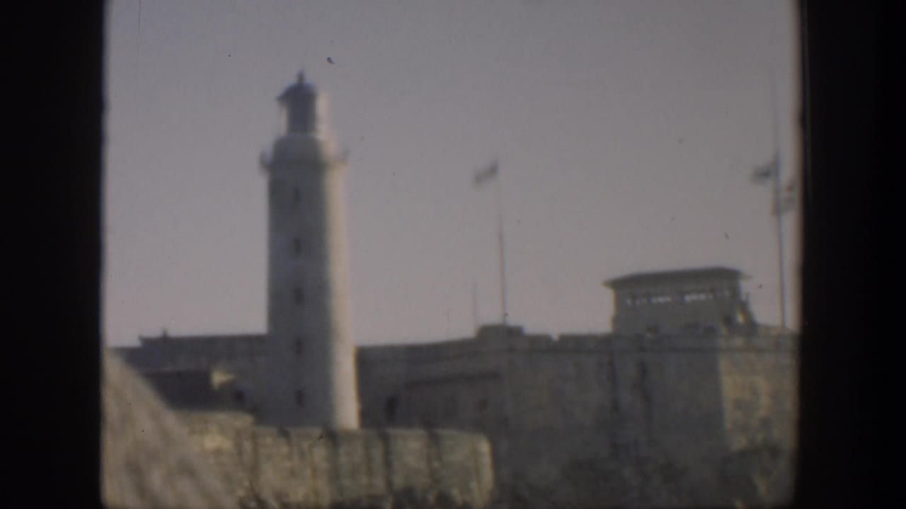 Lighthouse and walled complex seen from a low exterior angle.
