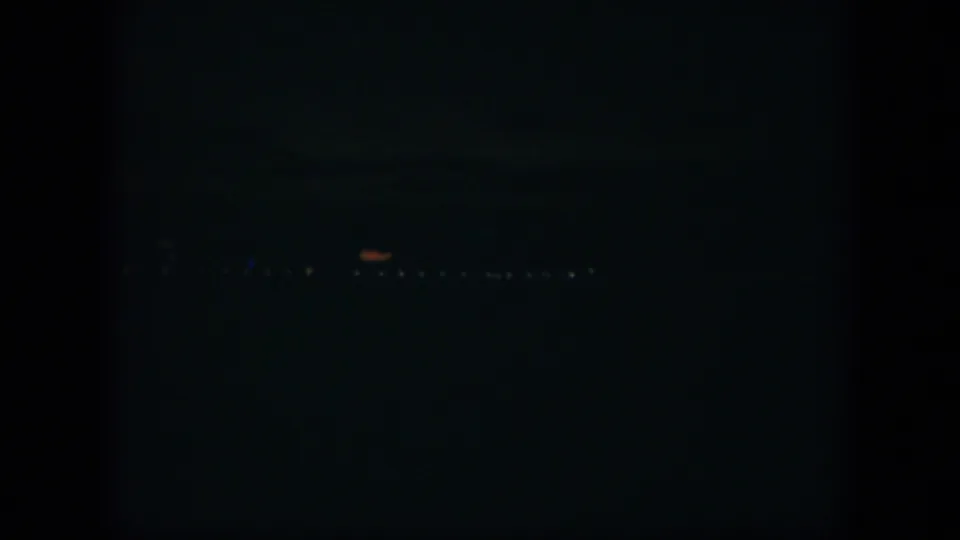 A dark 1951 Cuba night frame with a line of distant lights near the lower edge and minimal visible detail.