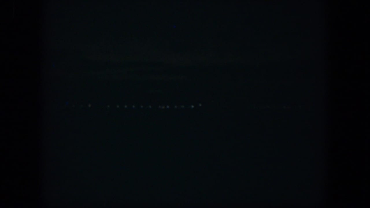 1951 Cuba 8mm night view with scattered distant lights against a mostly black field.