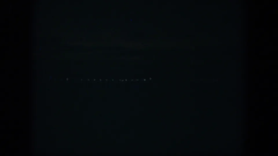 1951 Cuba 8mm night view with scattered distant lights against a mostly black field.