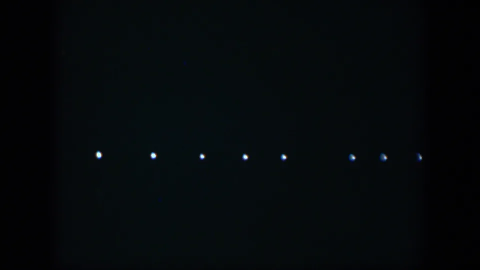 1951 Cuba night footage frame with a low row of small lights, possibly distant lamps or taillights.