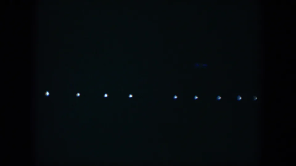1951 Cuba 8mm frame showing small white lights arranged across a dark, underexposed night sky.