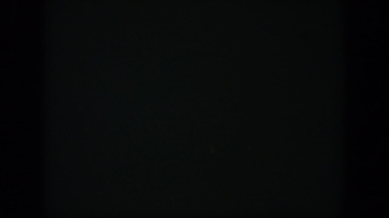 1951 Cuba 8mm frame appearing almost black, with faint blue-green exposure noise and a subtle horizontal division.