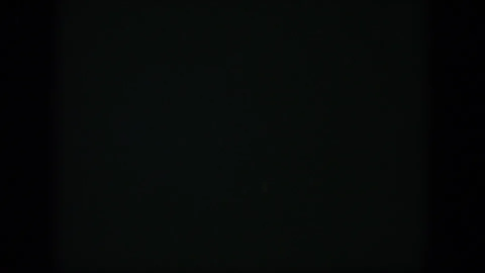 1951 Cuba 8mm frame appearing almost black, with faint blue-green exposure noise and a subtle horizontal division.