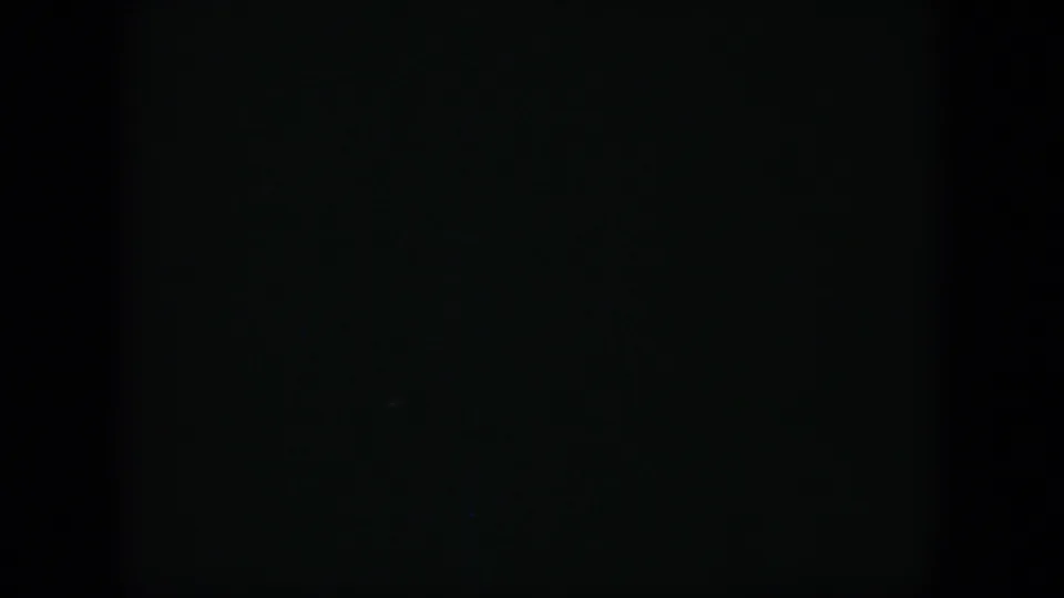 A very dark 8mm frame from the 1951 Cuba clip, with no clearly readable subject detail visible.