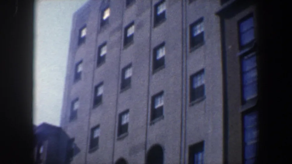 1962 Philadelphia upward-looking shot of a tall urban facade with repeated windows, a plain wall surface, and an arched lower opening.