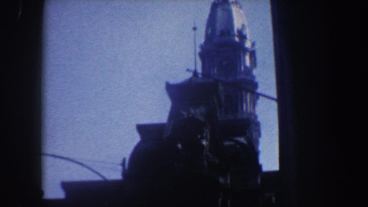 Tall tower silhouette with domed upper section and dark vertical framing.