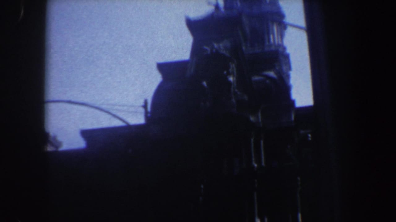 Shadowed tower and street details partly obscured by a dark vertical film area.