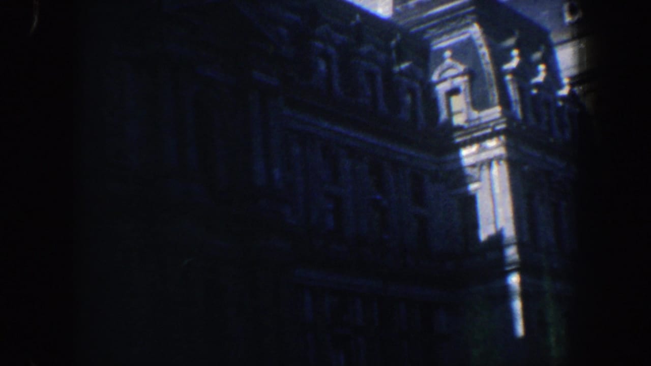 Darkened view of the same ornate facade with bright architectural trim at the edge.