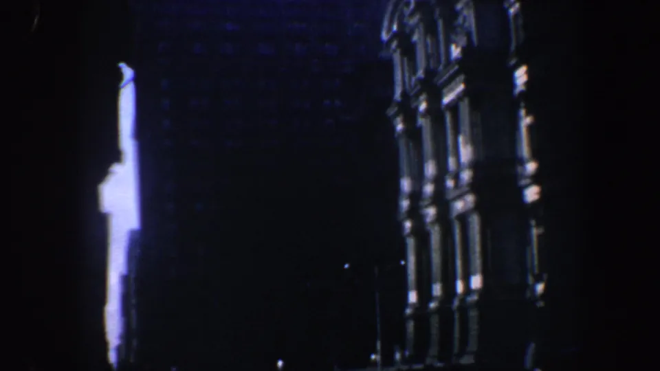 1962 Philadelphia frame showing the historic building at night, with a bright vertical illuminated area between dark architectural masses.