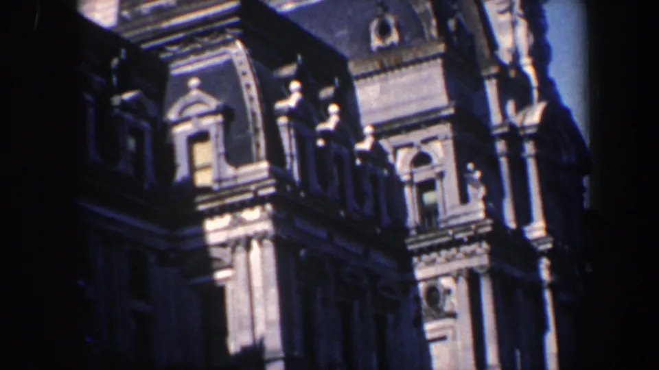 1962 Philadelphia daylight frame showing ornate masonry, dormer windows, columns, and carved details on a historic building exterior.