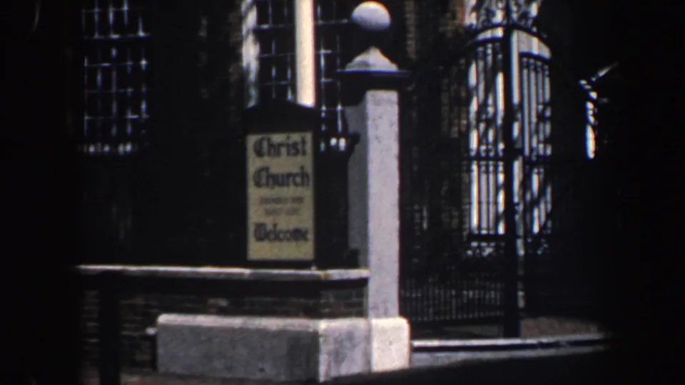 1962 Philadelphia frame shows the Christ Church welcome sign, stone gatepost, brickwork, and decorative black iron gate.