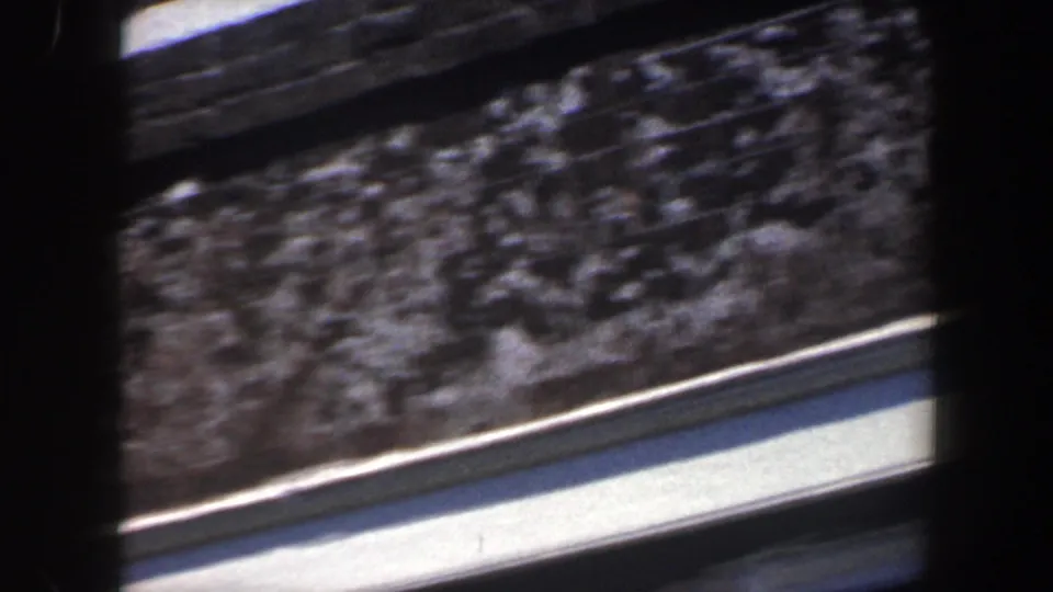 A late 1962 Philadelphia frame shows motion blur across a rough wall and pale ledge as the handheld camera shifts.