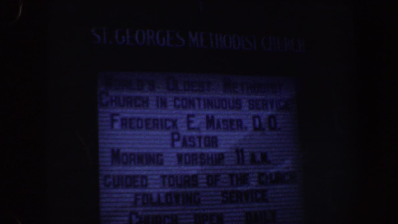 Close view of the illuminated St. George's Methodist Church schedule sign.