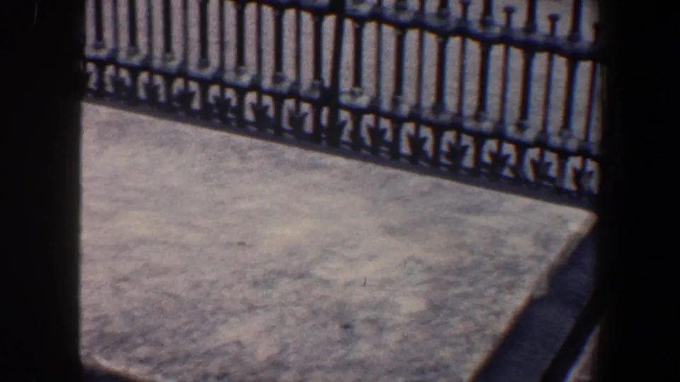 1962 Philadelphia frame with a concrete platform, iron gate, and heavy dark vertical edge shadows from the film or contact sheet.