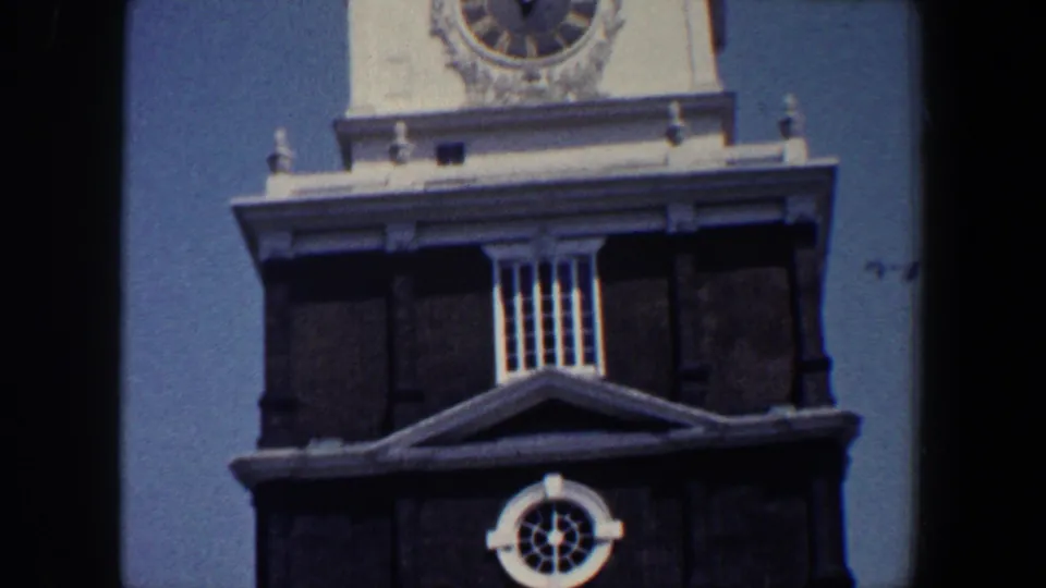 1962 Philadelphia frame showing the clock tower above a dark brick section with a circular white-trimmed window.