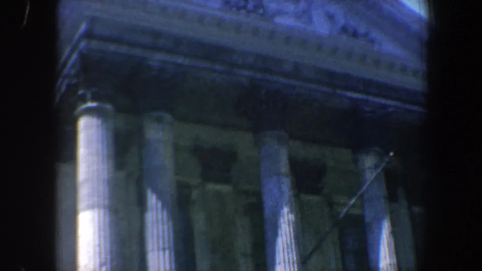 Handheld 8mm view of a Philadelphia classical facade with columns, entablature, and the underside of a triangular pediment.