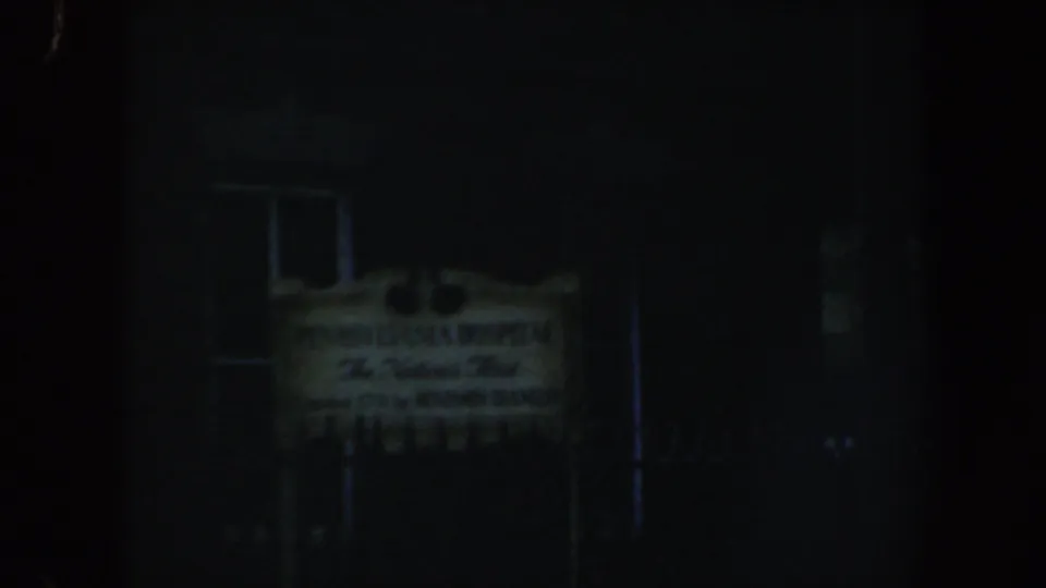 Low-light 1962 Philadelphia frame showing the Pennsylvania Hospital sign, dark windows, and shadowed exterior details.